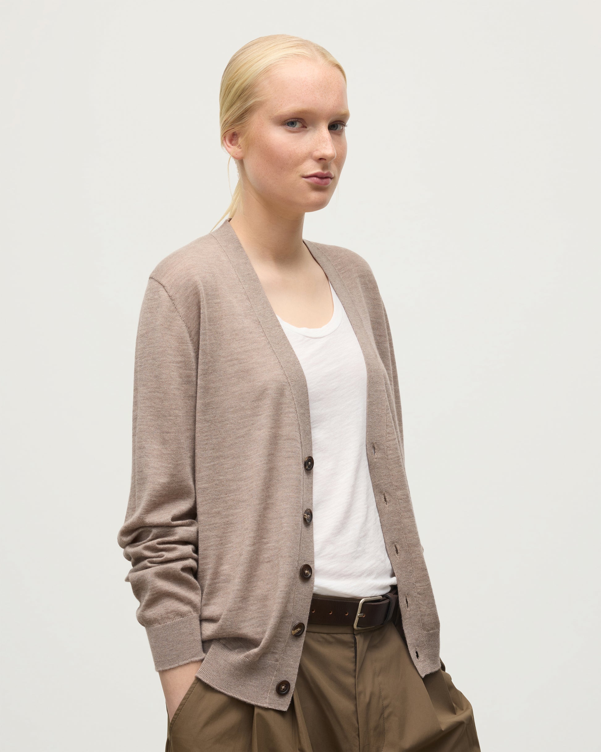 FEMALE MODEL WEARING JOHNSTONS OF ELGIN FORSYTH SUPERFINE VEE NECK CARDIGAN LIGHT BROWN KAI05740HB0273