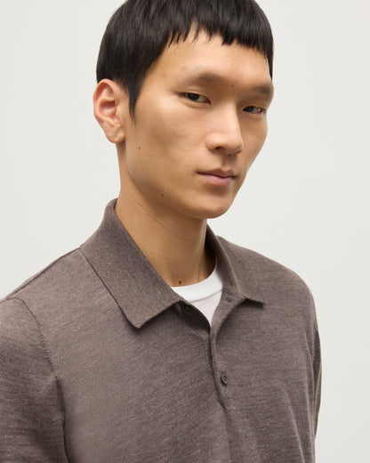 MODEL WEARS JOHNSTONS OF ELGIN MENS FIN SHORT SLEEVE SUPERFINE POLOSHIRT LIGHT BROWN OVER A WHITE T-SHIRT  KAI05741HB7092