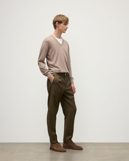 MENS FIN SUPERFINE VEE NECK LIGHT BROWN 100% SUPERFINE CASHMERE BY JOHNSTONS OF ELGIN, WORN OVER A WHITE T-SHIRT WITH OLIVE GREEN TROUSERS  KAI05744HB0273