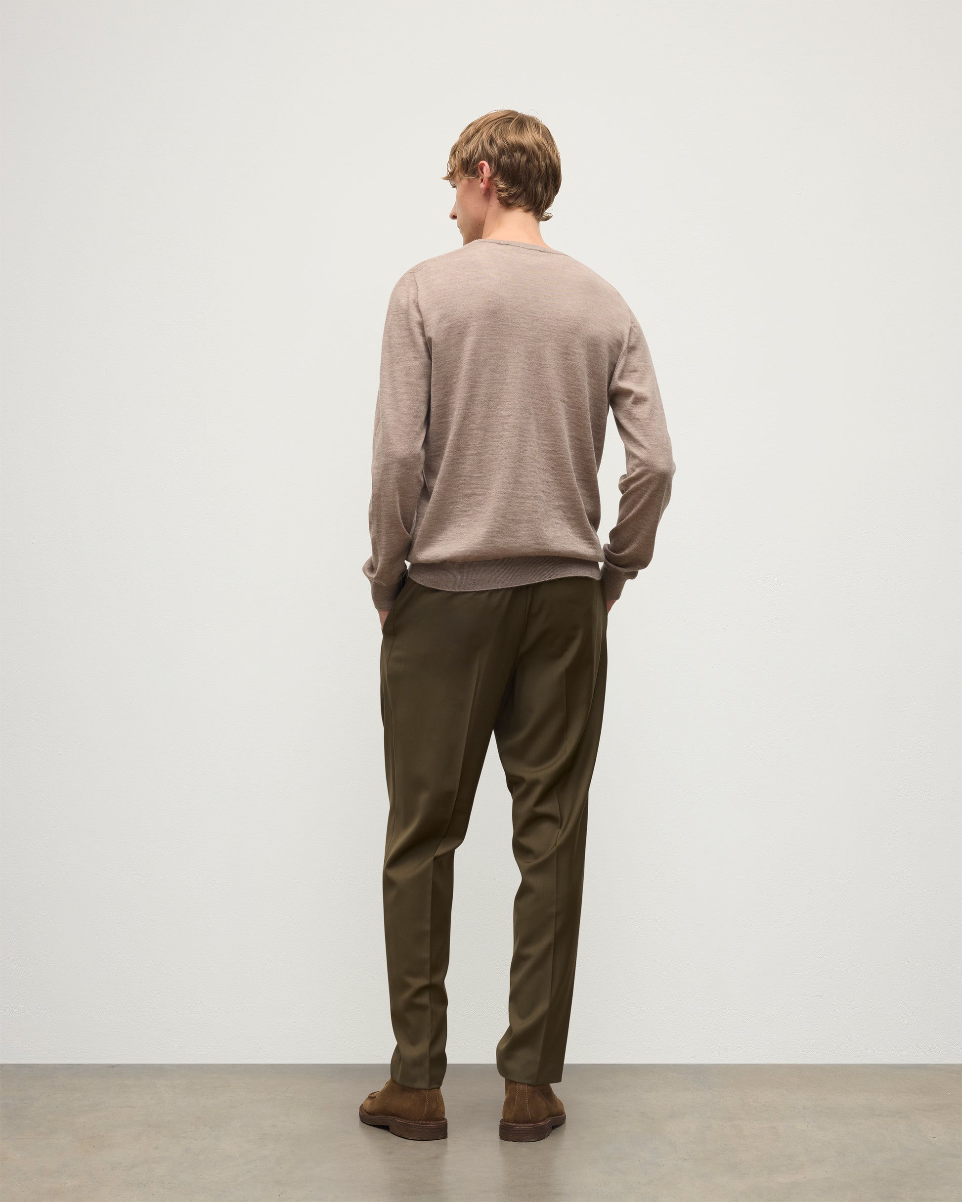 MENS FIN SUPERFINE VEE NECK LIGHT BROWN 100% SUPERFINE CASHMERE BY JOHNSTONS OF ELGIN, WORN OVER A WHITE T-SHIRT WITH OLIVE GREEN TROUSERS  KAI05744HB0273