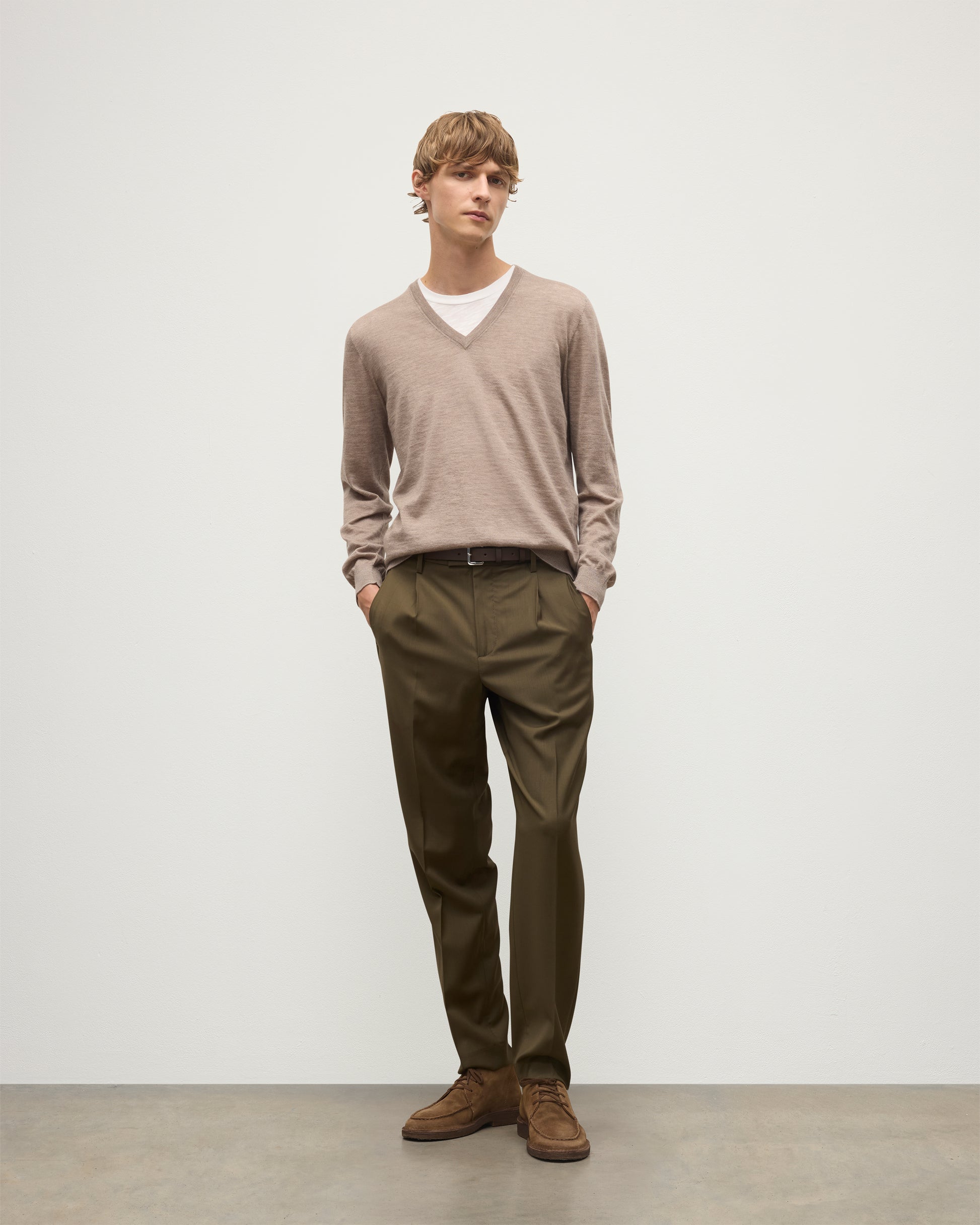 MENS FIN SUPERFINE VEE NECK LIGHT BROWN 100% SUPERFINE CASHMERE BY JOHNSTONS OF ELGIN, WORN OVER A WHITE T-SHIRT WITH OLIVE GREEN TROUSERS  KAI05744HB0273