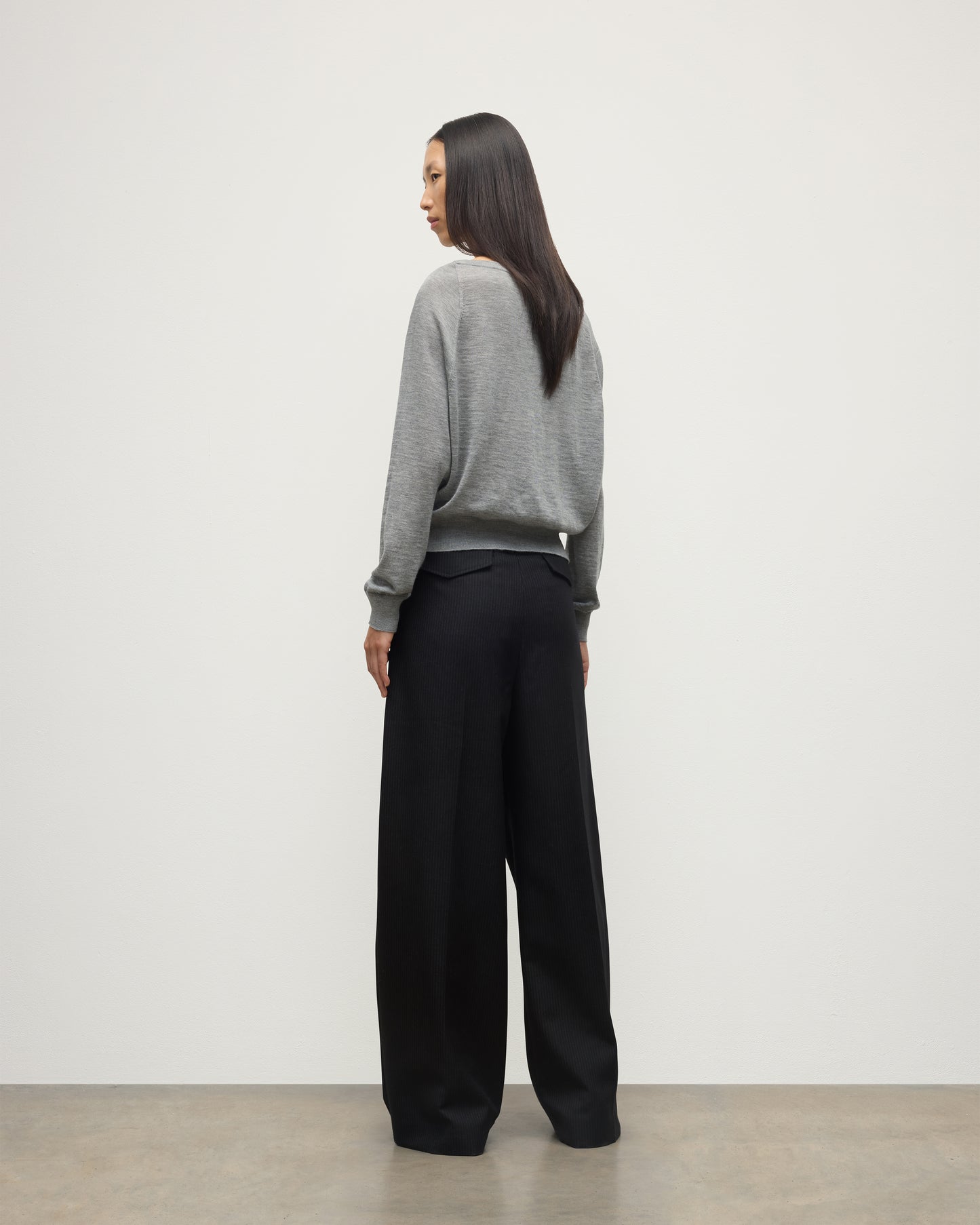 MODEL WEARS JOHNSTONS OF ELGIN WOMENS FINOLA SWEATER GREY WITH BLACK TROUSERS KAI05789HA4253