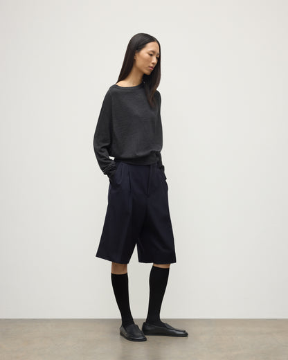 MODEL WEARING JOHNSTONS OF ELGIN WOMENS FINOLA SWEATER GREY 100% SUPERFINE CASHMERE  WITH BLACK LONG SHIRTS, SOCKS AND LOAFERS KAI05789HA7218