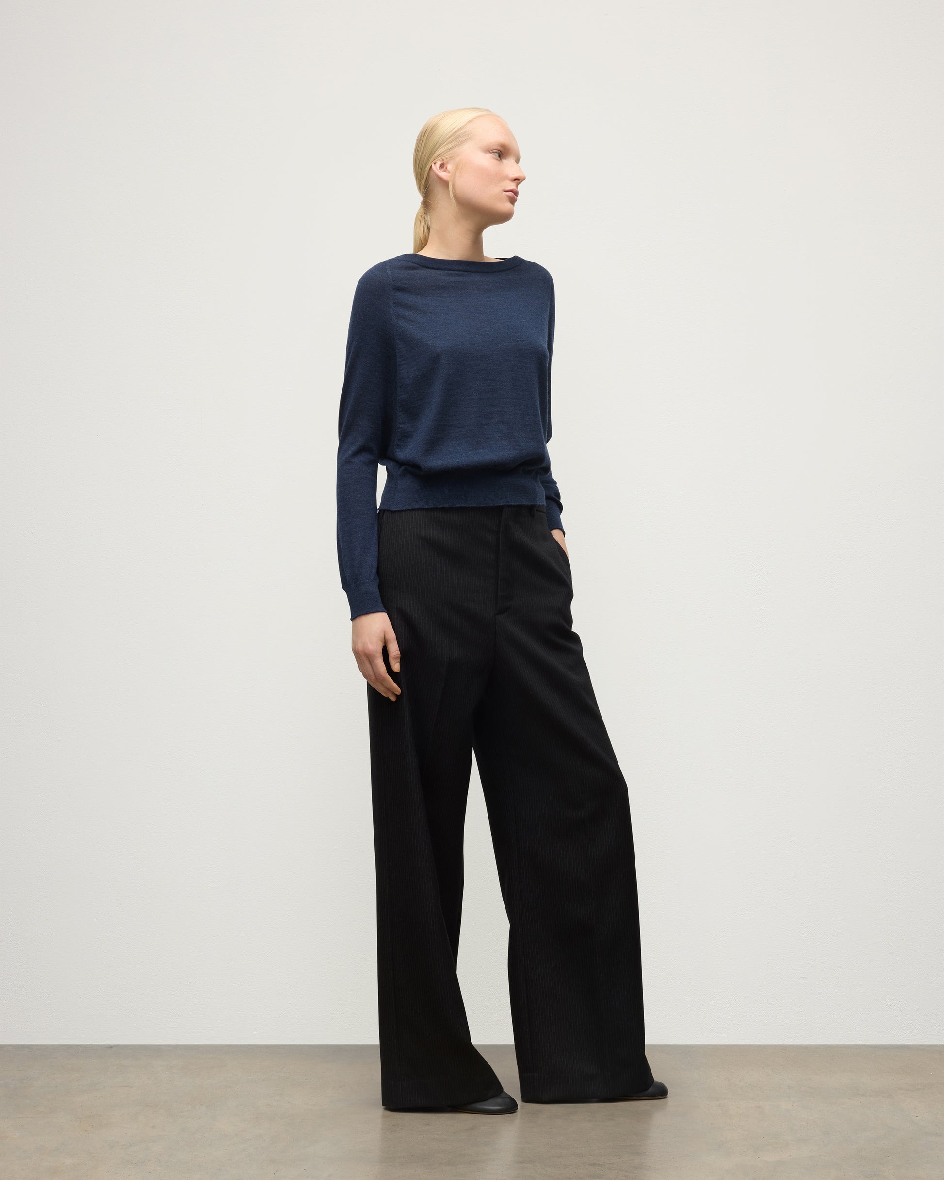 MODEL WEARS JOHNSTONS OF ELGIN WOMENS FINOLA SWEATER NAVY 100% SUPERFINE CASHMERE  WITH BLACK TROUSERS KAI05789HD7350