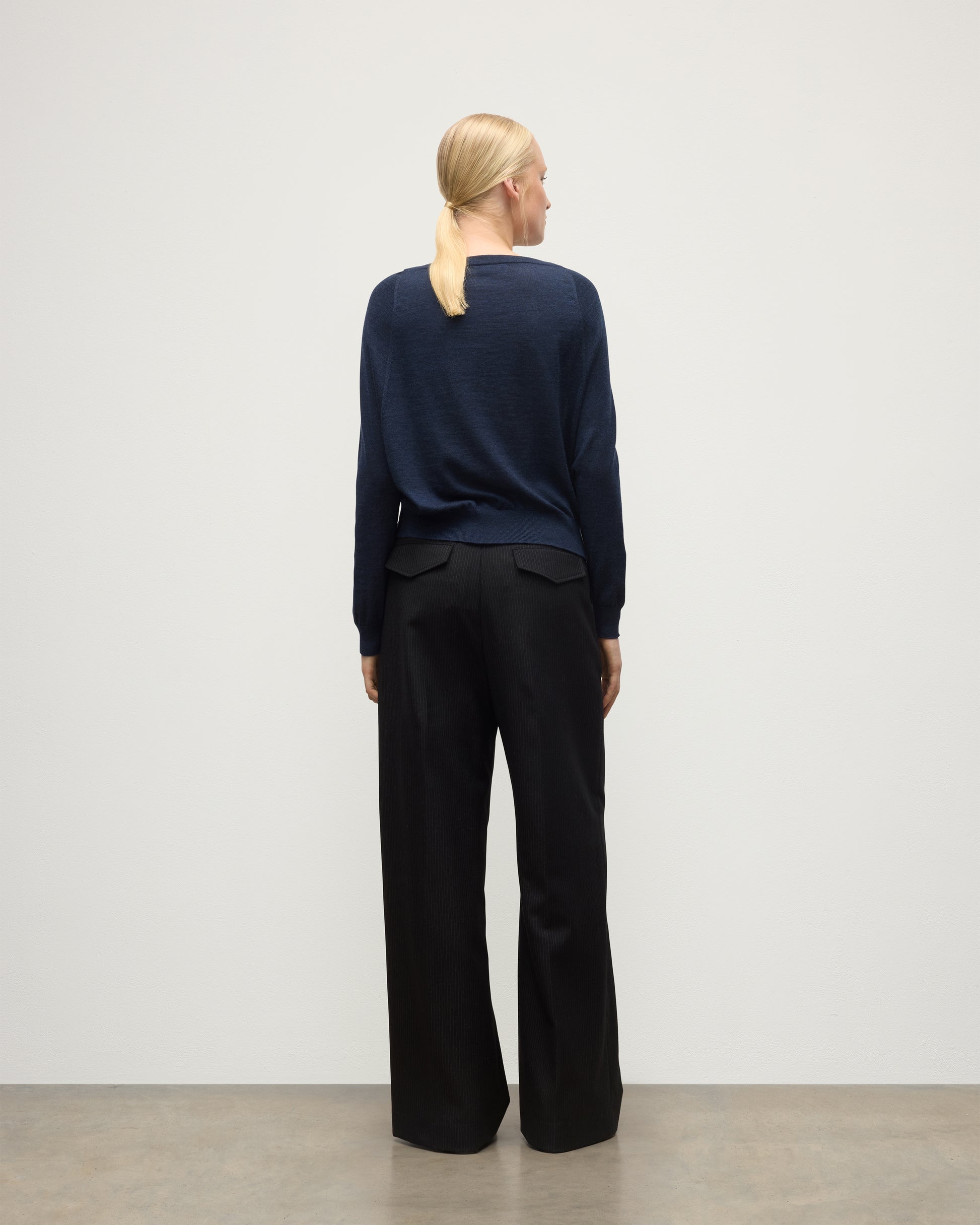 MODEL WEARS JOHNSTONS OF ELGIN WOMENS FINOLA SWEATER NAVY 100% SUPERFINE CASHMERE  WITH BLACK TROUSERS KAI05789HD7350