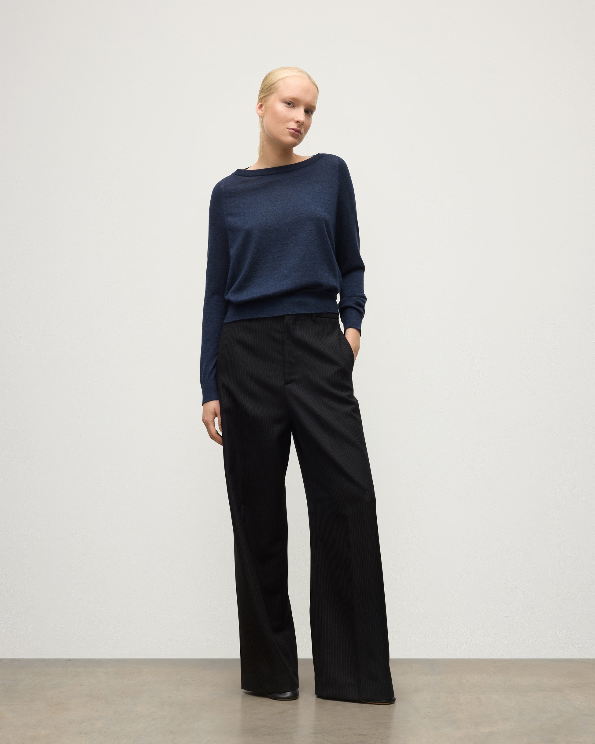 MODEL WEARS JOHNSTONS OF ELGIN WOMENS FINOLA SWEATER NAVY 100% SUPERFINE CASHMERE  WITH BLACK TROUSERS KAI05789HD7350