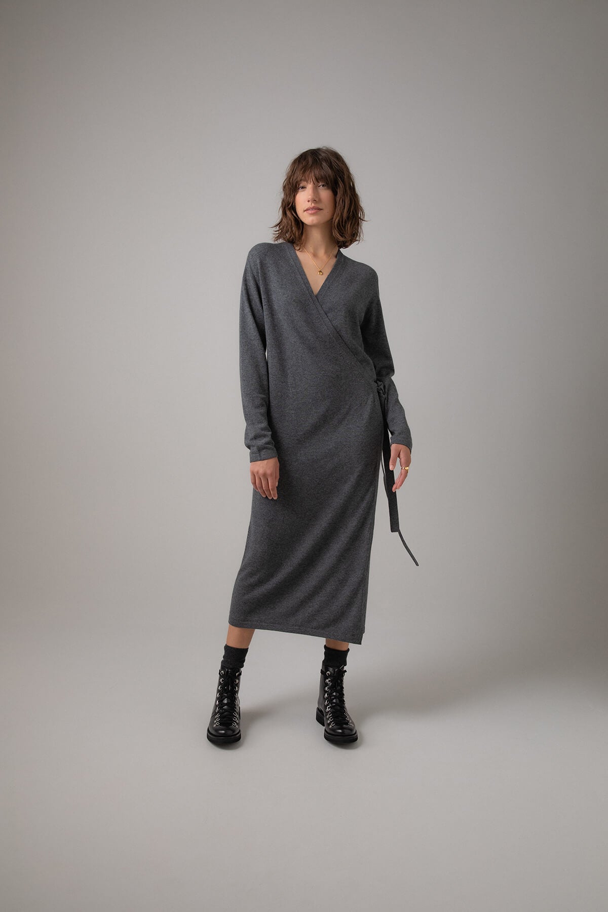Johnstons of Elgin Ballet Wrap Cashmere Dress in Mid Grey worn with Cashmere Socks & Shoes on a grey background KAP05047HA4181