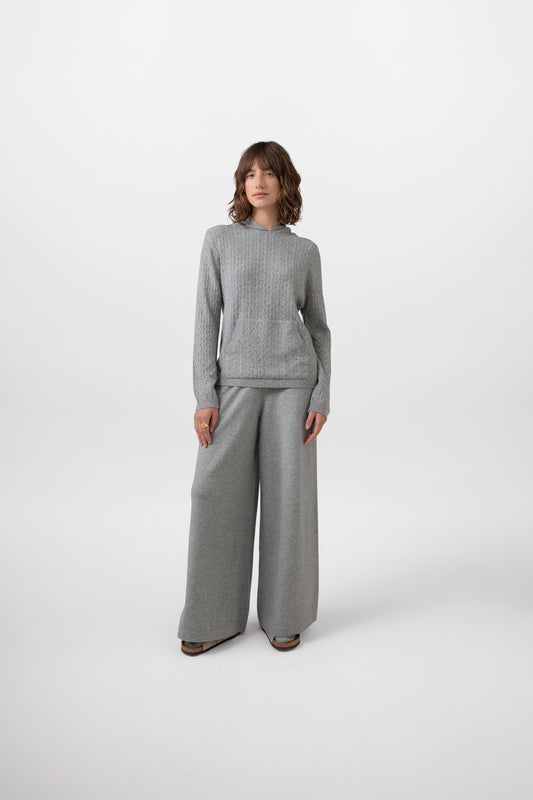 Johnstons of Elgin Low Rise Women's Cashmere Slouch Pants in Light Grey worn with matching Cashmere Sweater on a grey background KBP00924HA0308