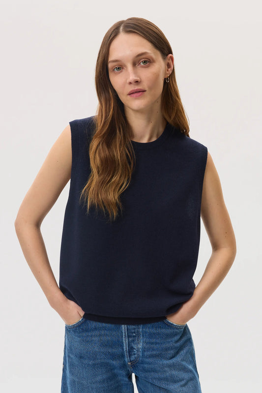 Female model wearing Johnstons of Elgin SS25 Unisex Knitwear Navy Cashmere Tank with blue barrel leg jeans KAP05243SD7286