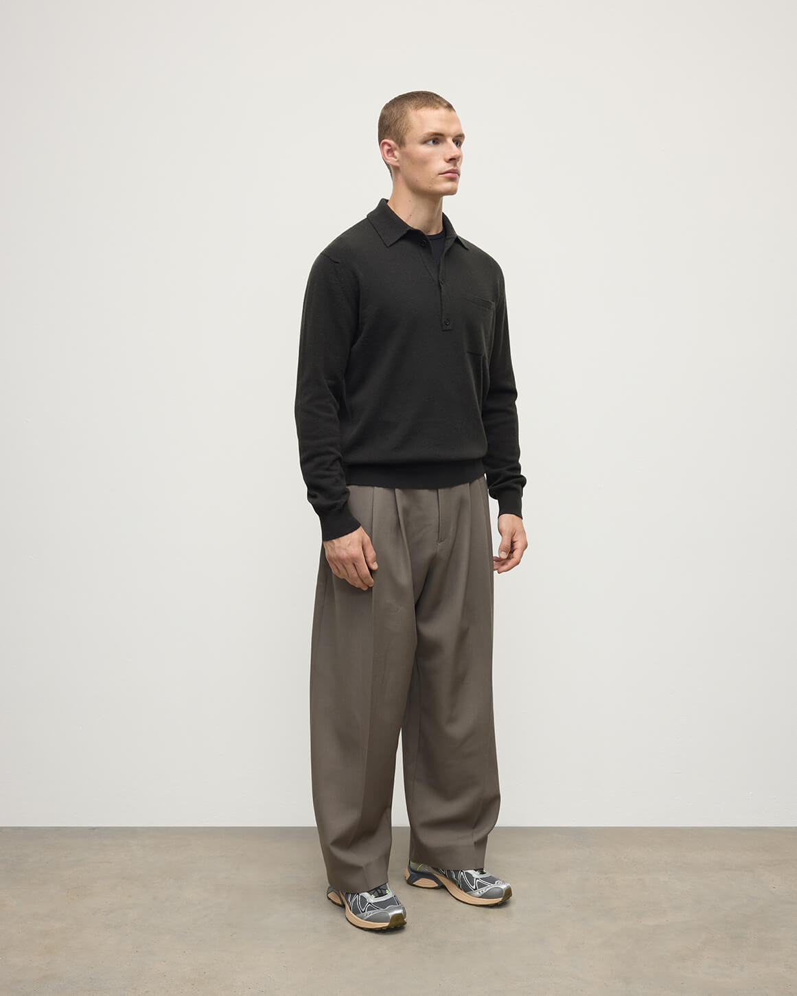 Johnstons of Elgin AW25 Men's Knitwear Iron Cashmere Long Sleeve Grey Poloshirt worn by model side view KAP05268Q25357