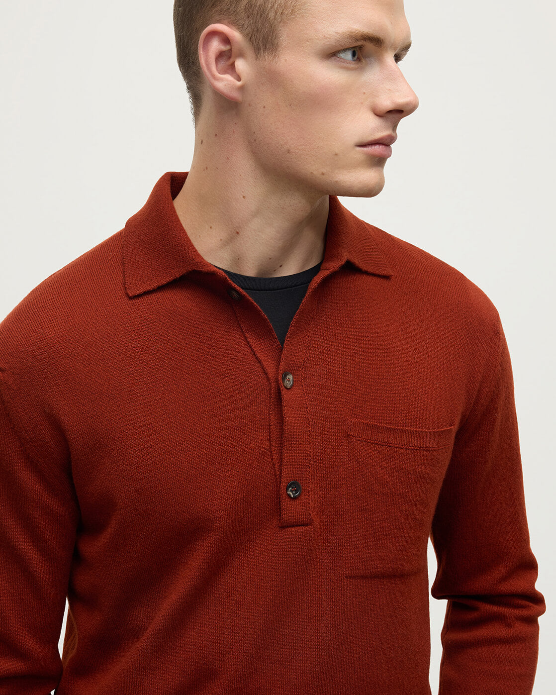 Model wearing Johnstons of Elgin AW25 Men's Knitwear Oxblood Cashmere Long Sleeve Red Polo shirt  details view KAP05268Q25358