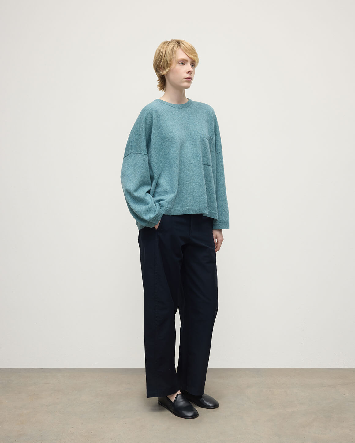 Model wearing Johnstons of Elgin AW25 Women's Knitwear Seascape Gauzy Pocket Green Cashmere Jumper Side View  KAP05315HC0038