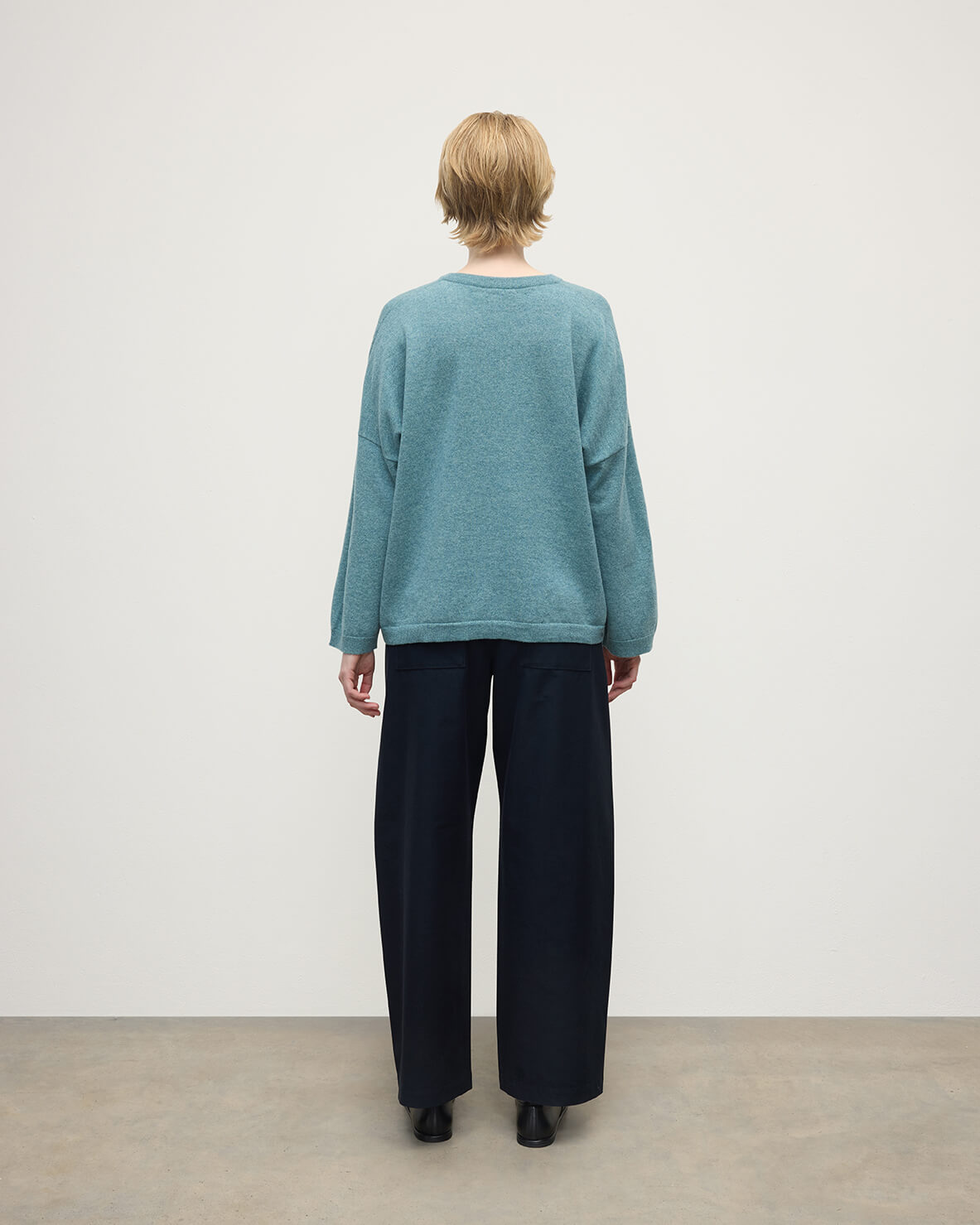 Model wearing Johnstons of Elgin AW25 Women's Knitwear Seascape Gauzy Pocket Green Cashmere Jumper back View  KAP05315HC0038