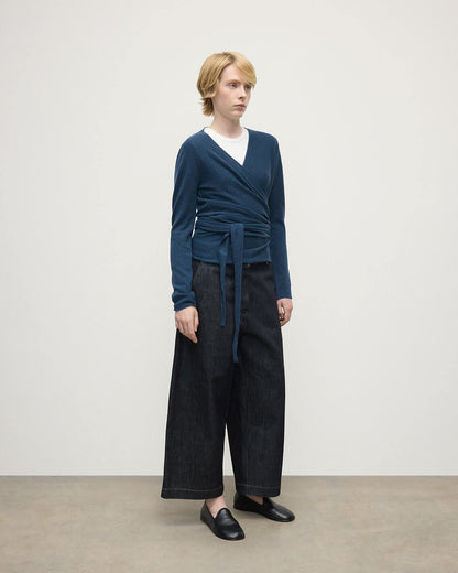 Model wears Johnstons of Elgin AW25 Women's Knitwear Heather Navy Ballet Wrap Navy Cashmere Cardigan Side View KAP05408HD7321