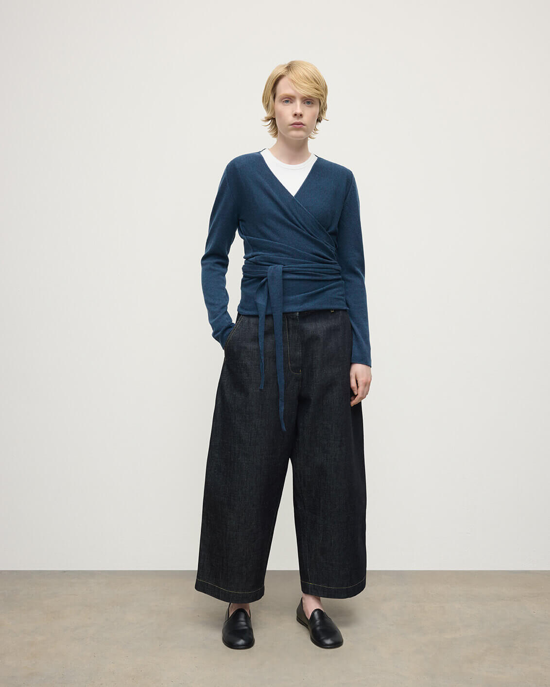 Model wears Johnstons of Elgin AW25 Women's Knitwear Heather Navy Ballet Wrap Navy Cashmere Cardigan Front View KAP05408HD7321