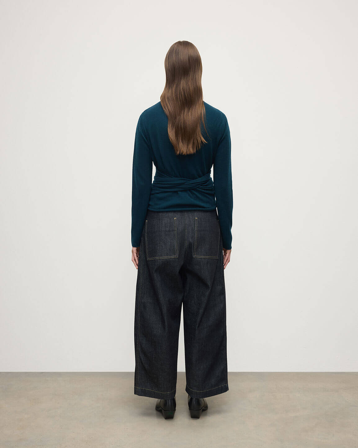 Model wearing Johnstons of Elgin AW25 Women's Knitwear Bottle Green Ballet Wrap Green Cashmere Cardigan Back View KAP05408SC7341