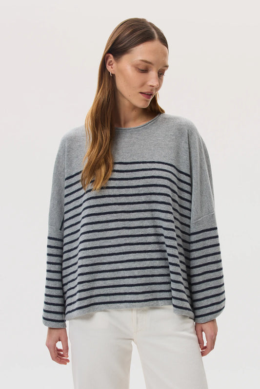 Model wears Johnstons of Elgin SS25 Women's Knitwear Light Grey & Navy Relaxed Featherlight Cashmere Stripe Jumper with white jeans  KAP05425Q25142