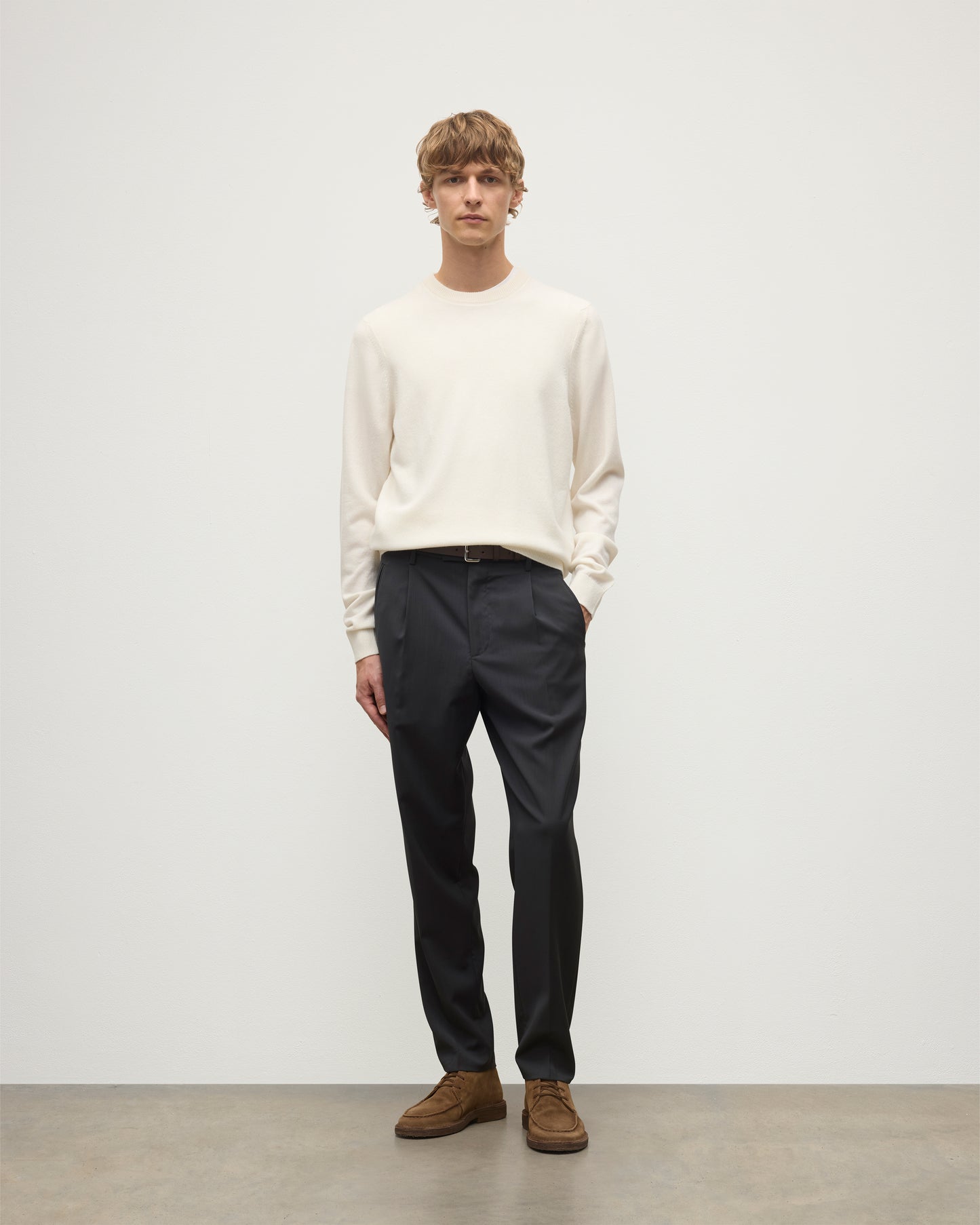 MODEL WEARS JOHNSTONS OF ELGIN MENS RORY CREW CLASSIC JUMPER WHITE 100% CASHMERE WITH GREY TROUSERS AND BROWN BELT AND SHOES KAP05471SA0606