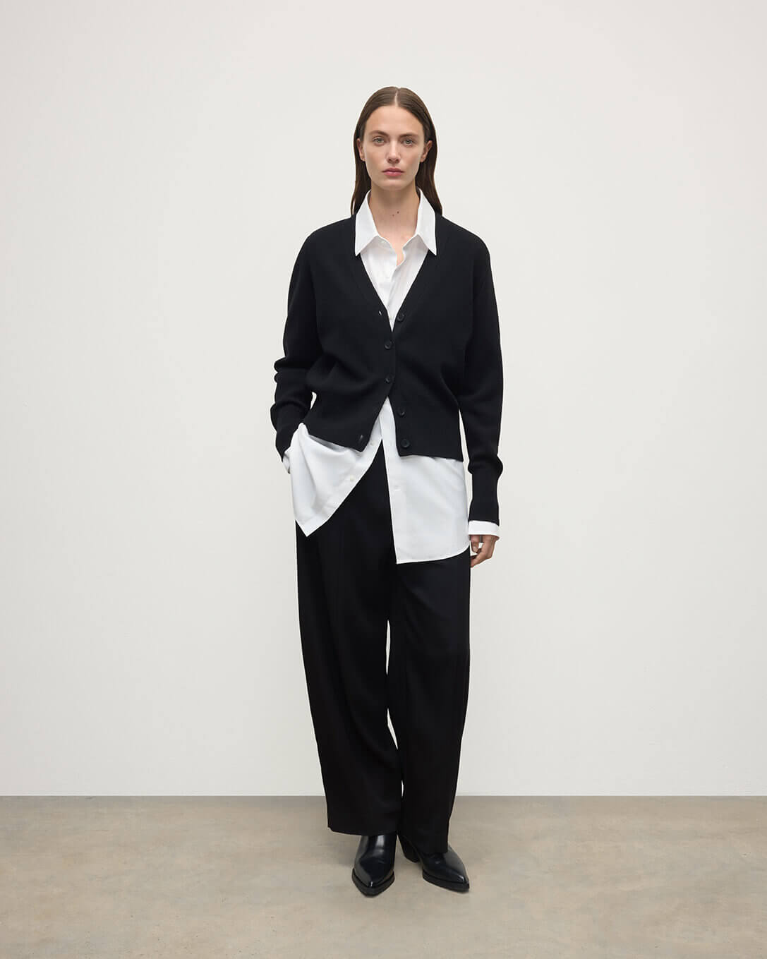 Model wears Johnstons of Elgin  Women's Knitwear Black Milano Stitch Black Cashmere Cardigan over a white shirt Front View KAP05489SA7210