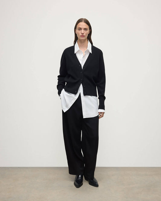 Model wears Johnstons of Elgin  Women's Knitwear Black Milano Stitch Black Cashmere Cardigan over a white shirt Front View KAP05489SA7210