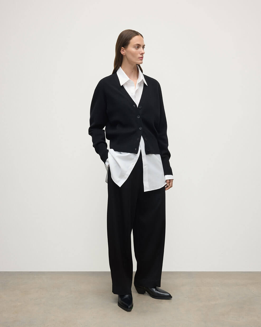 Model wears Johnstons of Elgin  Women's Knitwear Black Milano Stitch Black Cashmere Cardigan over a white shirt Front View KAP05489SA7210