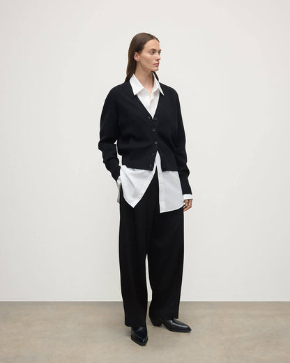 Model wears Johnstons of Elgin  Women's Knitwear Black Milano Stitch Black Cashmere Cardigan over a white shirt Front View KAP05489SA7210