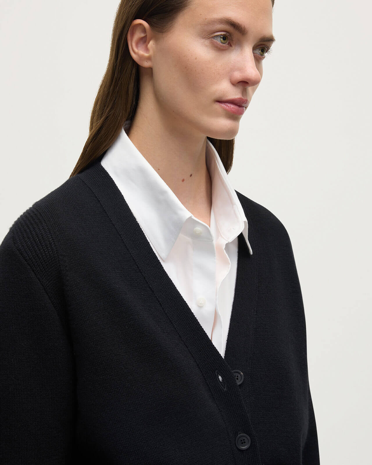 Model wears Johnstons of Elgin  Women's Knitwear Black Milano Stitch Black Cashmere Cardigan over a white shirt Front View KAP05489SA7210