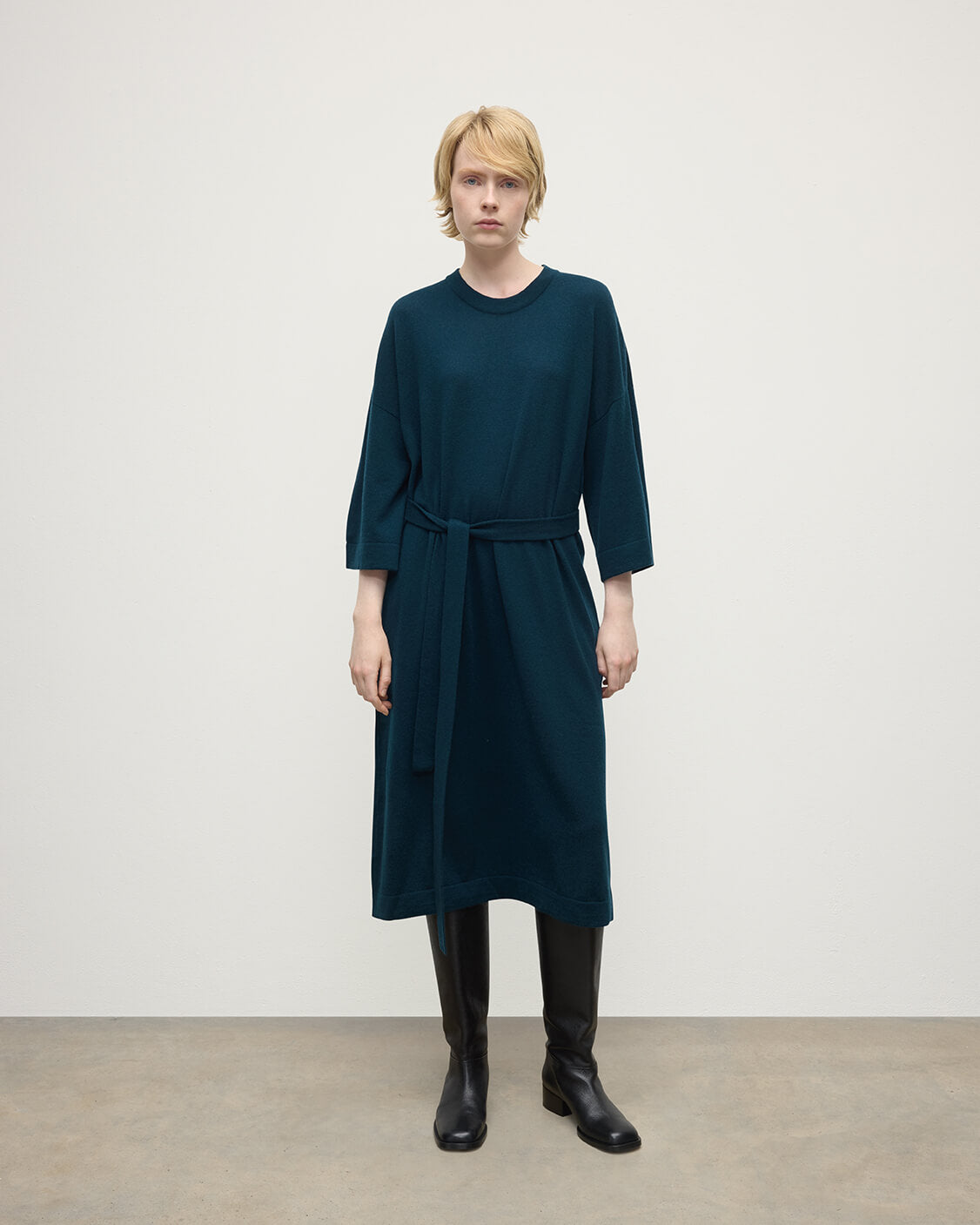 Model wears Johnstons of Elgin AW25 Women's Knitwear Bottle Green Tie-Waist Cashmere Green Jumper Dress Front View  KAP05490SC7341