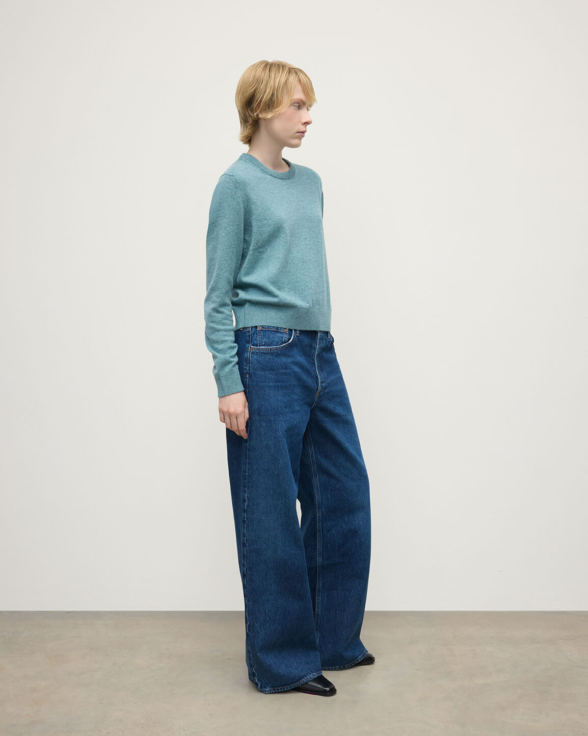 Model wearing Johnstons of Elgin AW25 Women's Knitwear Seascape Classic Cashmere Green Round Neck Jumper Side View  KAP05572HC0038