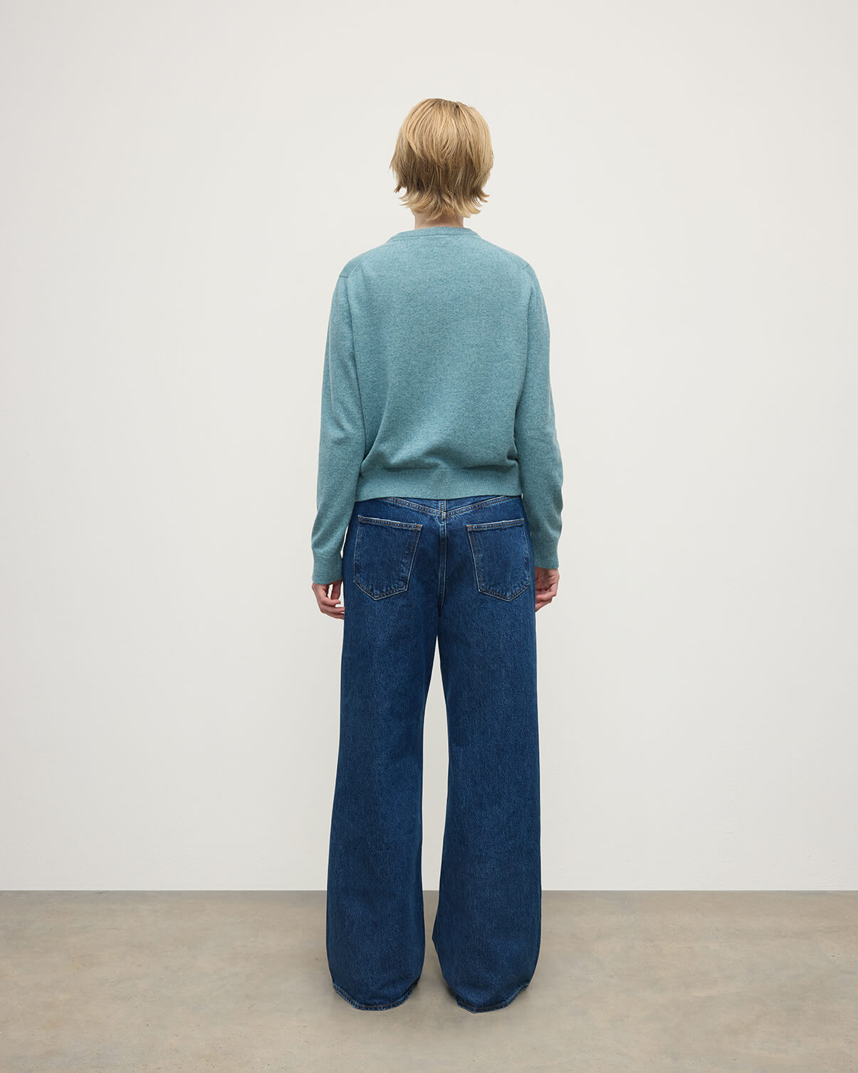 Model wearing Johnstons of Elgin AW25 Women's Knitwear Seascape Classic Cashmere Green Round Neck Jumper Back View  KAP05572HC0038