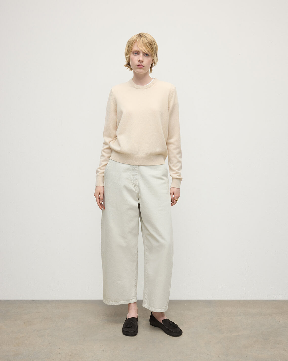 model wearing Johnstons of Elgin AW25 Women's Knitwear Champagne Classic Cashmere Cream Round Neck Jumper Front View KAP05572SA0502