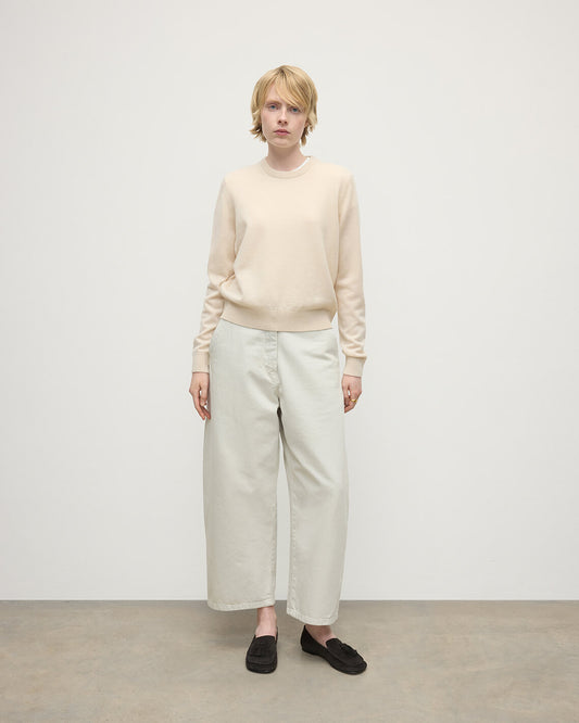 model wearing Johnstons of Elgin AW25 Women's Knitwear Champagne Classic Cashmere Cream Round Neck Jumper Front View KAP05572SA0502