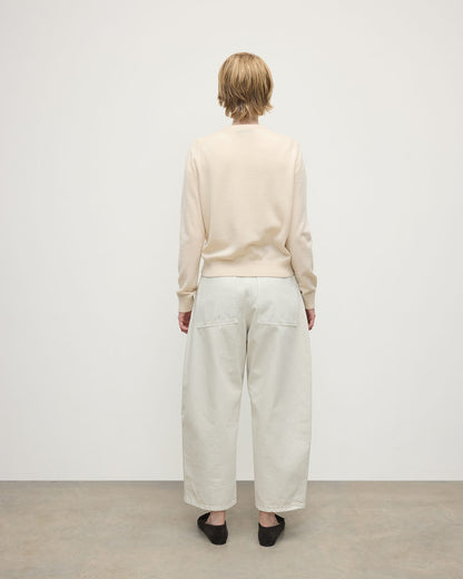 model wearing Johnstons of Elgin AW25 Women's Knitwear Champagne Classic Cashmere Cream Round Neck Jumper back View KAP05572SA0502