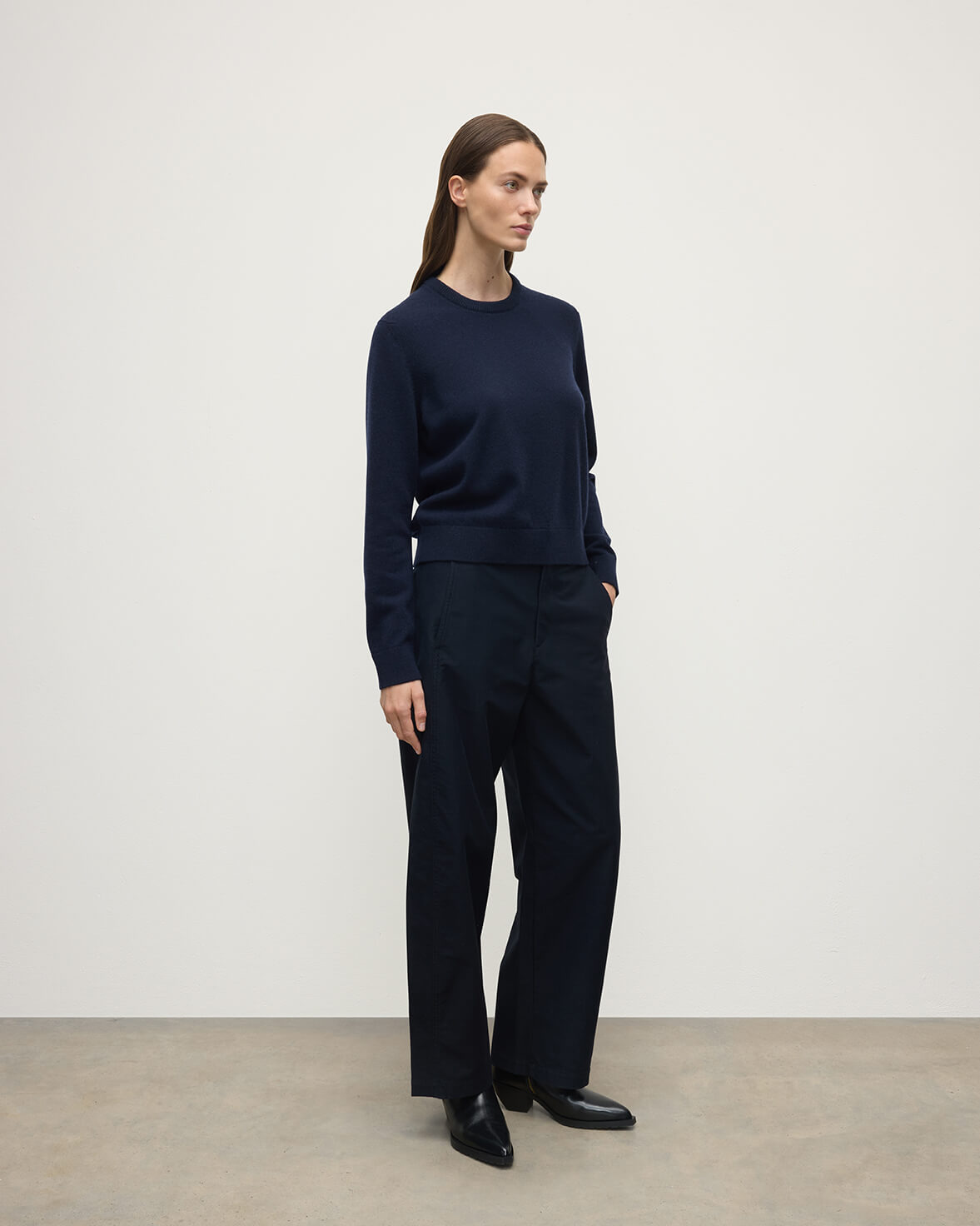 Model wearing Johnstons of Elgin AW25 Women's Knitwear Dark Navy Classic Cashmere Navy Round Neck Jumper side View  KAP05572SD7666