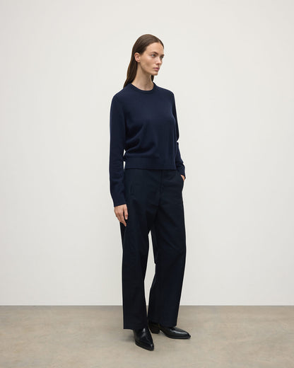 Model wearing Johnstons of Elgin AW25 Women's Knitwear Dark Navy Classic Cashmere Navy Round Neck Jumper side View  KAP05572SD7666