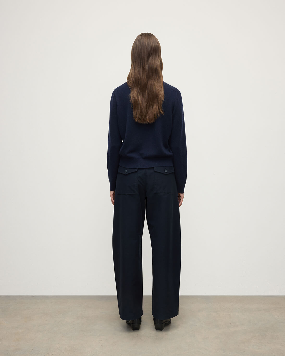 Model wearing Johnstons of Elgin AW25 Women's Knitwear Dark Navy Classic Cashmere Navy Round Neck Jumper back View  KAP05572SD7666