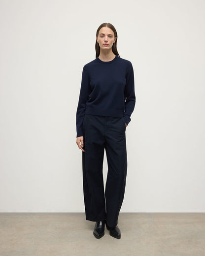 Model wearing Johnstons of Elgin AW25 Women's Knitwear Dark Navy Classic Cashmere Navy Round Neck Jumper front View  KAP05572SD7666