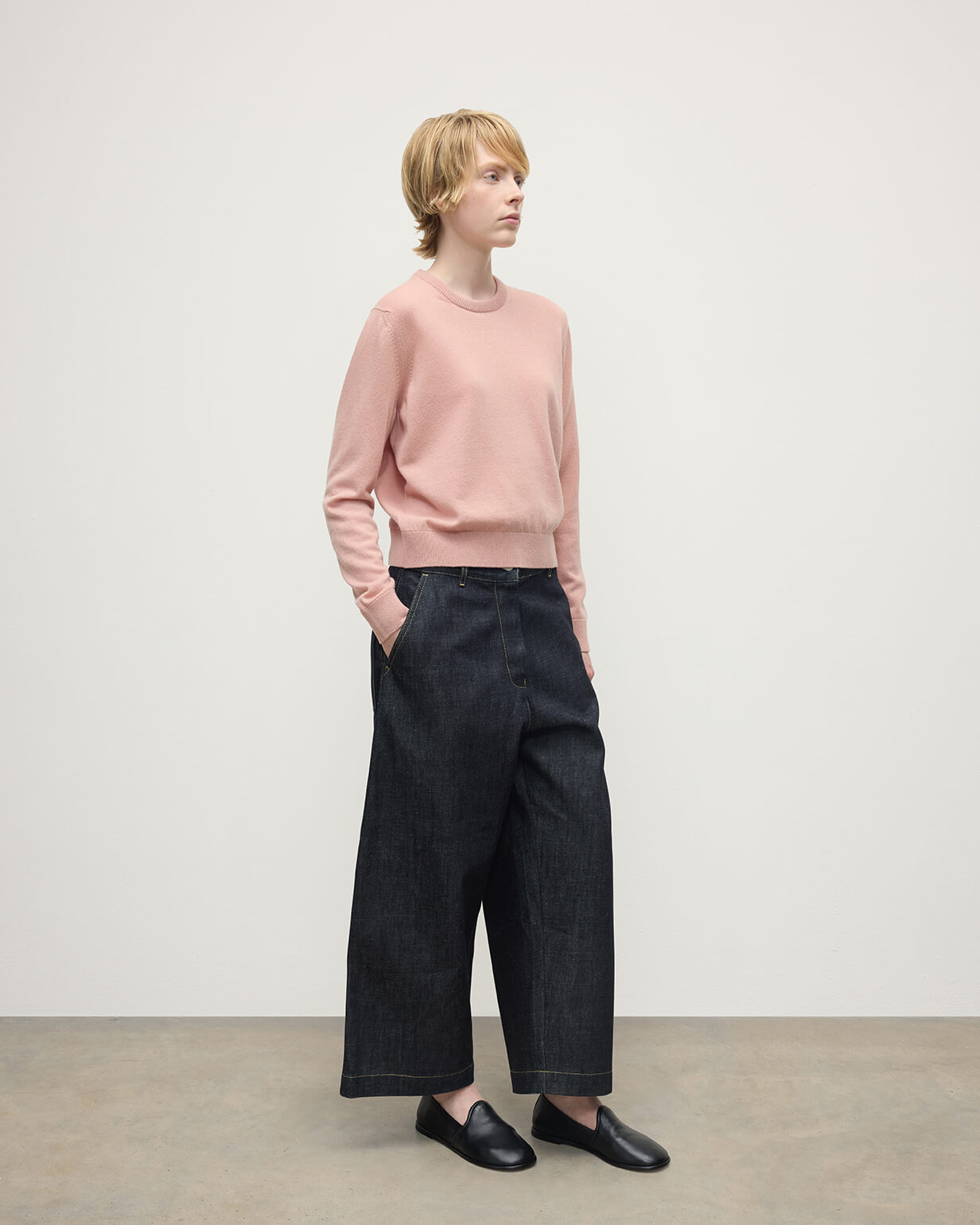 Model wears Johnstons of Elgin AW25 Women's Knitwear Nude Classic Cashmere Pink Round Neck Jumper Side View KAP05572SE0740