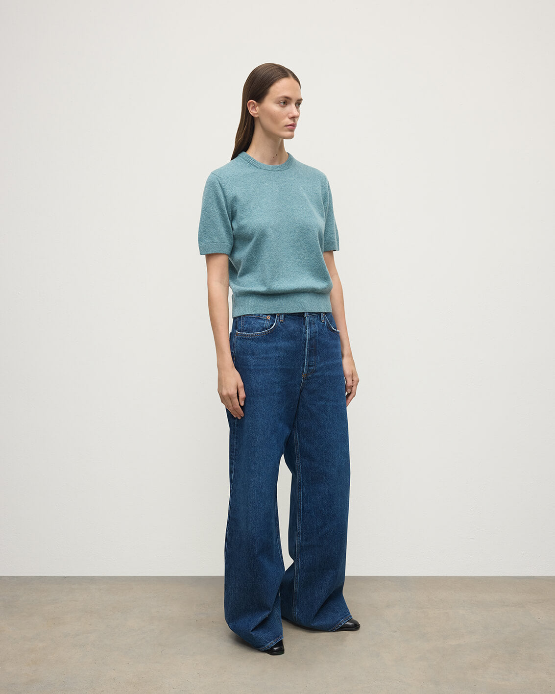 Model wears Johnstons of Elgin AW25 Women's Knitwear Seascape Classic Cashmere Green T-shirt Side View KAP05574HC0038