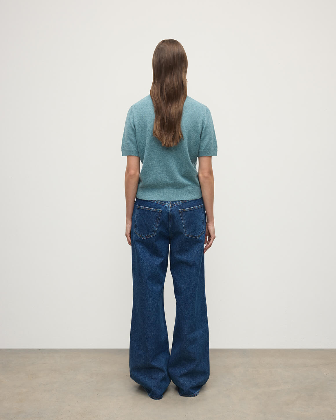 Model wears Johnstons of Elgin AW25 Women's Knitwear Seascape Classic Cashmere Green T-shirt Back View KAP05574HC0038