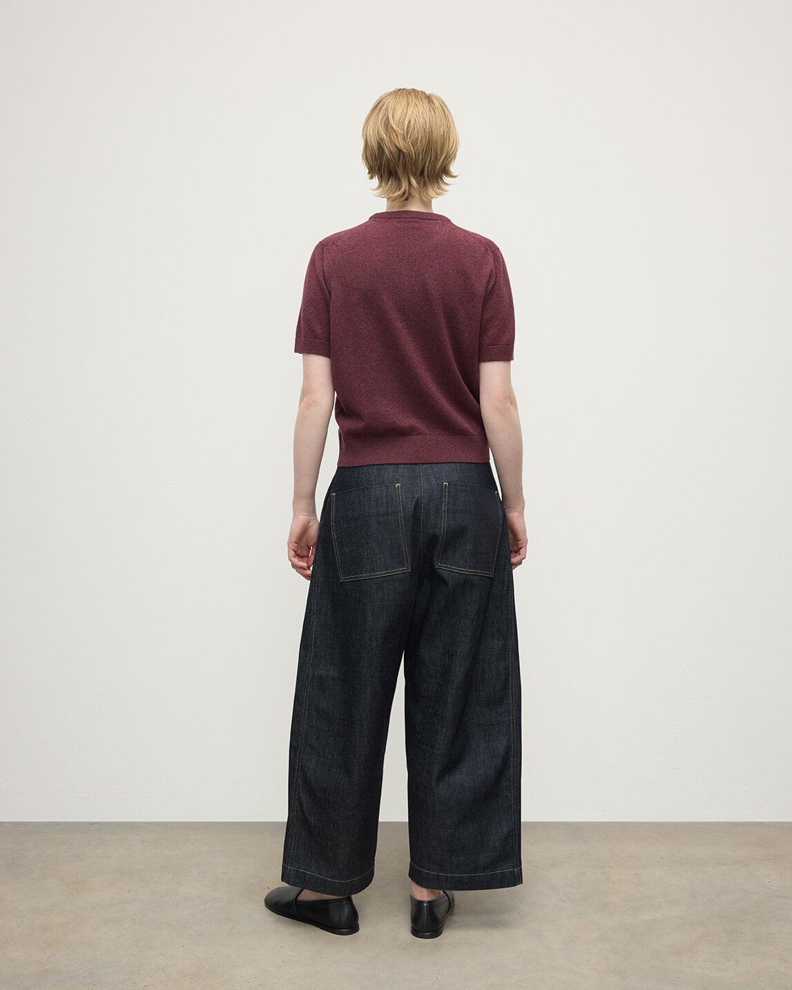 Model wears Johnstons of Elgin AW25 Women's Knitwear Damson Classic Cashmere Purple T-shirt Back KAP05574HE7064