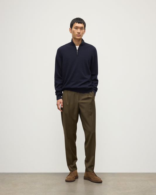 MODEL WEARS JOHNSTONS OF ELGIN MENS RORY CLASSIC HALF ZIP SWEATER CONTRAST TRIM NAVY & CHARCOAL 100% CASHMERE, OVER A WHITE T-SHIRT WITH OLIVE GREEN TROUSERS KAP05577Q26187