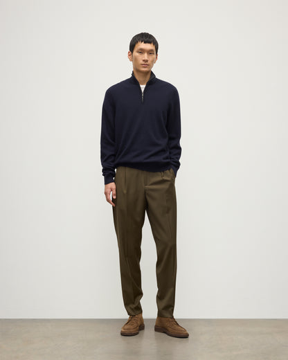 MODEL WEARS JOHNSTONS OF ELGIN MENS RORY CLASSIC HALF ZIP SWEATER CONTRAST TRIM NAVY & CHARCOAL 100% CASHMERE, OVER A WHITE T-SHIRT WITH OLIVE GREEN TROUSERS KAP05577Q26187
