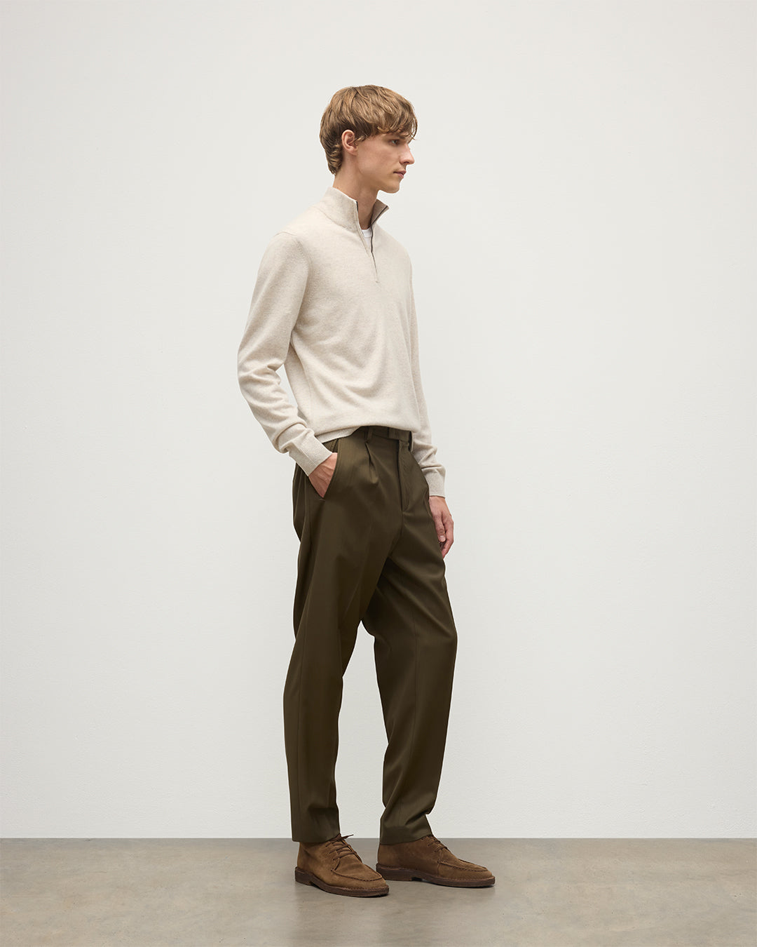 MODEL WEARING JOHNSTONS OF ELGIN MENS RORY CLASSIC HALF ZIP CLASSIC SWEATER 100% CASHMERE WITH OLIVE GREEN TROUSERS KAP05695HA0402