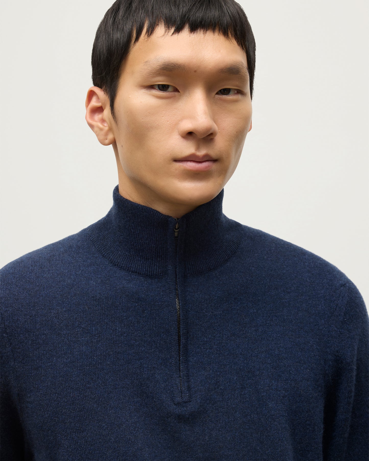 MODEL WEARS JOHNSTONS OF ELGIN MENS RORY CLASSIC HALF ZIP CLASSIC SWEATER 100% CASHMERE  OVER A WHITE T-SHIRT  KAP05695HD7350