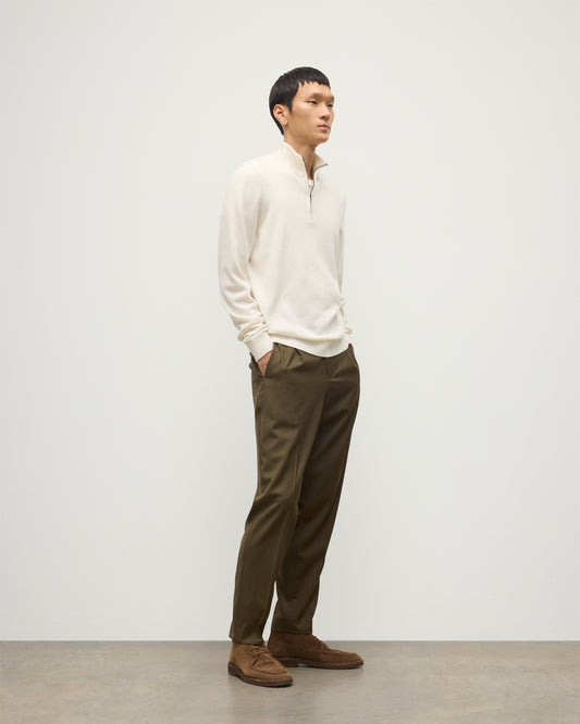 MODEL WEARS JOHNSTONS OF ELGIN MENS RORY CLASSIC HALF ZIP CLASSIC SWEATER 100% CASHMERE OVER A WHITE T-SHIRT WITH OLIVE GREEN TROUSERS KAP05695SA0606