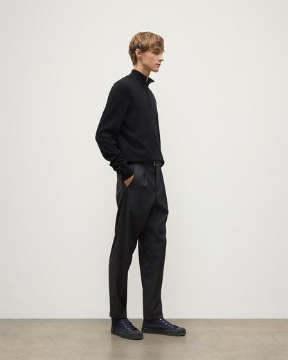 Model wears Johnstons of Elgin Men's Knitwear Rory Black Classic Cashmere Black Zip Neck Jumper KAP05695SA7210