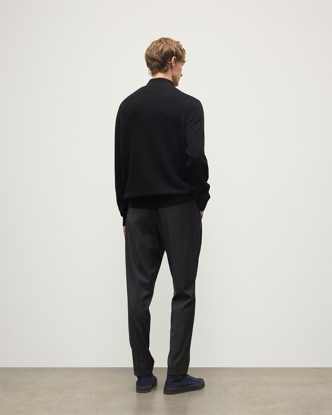 Model wears Johnstons of Elgin Men's Knitwear Rory Black Classic Cashmere Black Zip Neck Jumper KAP05695SA7210