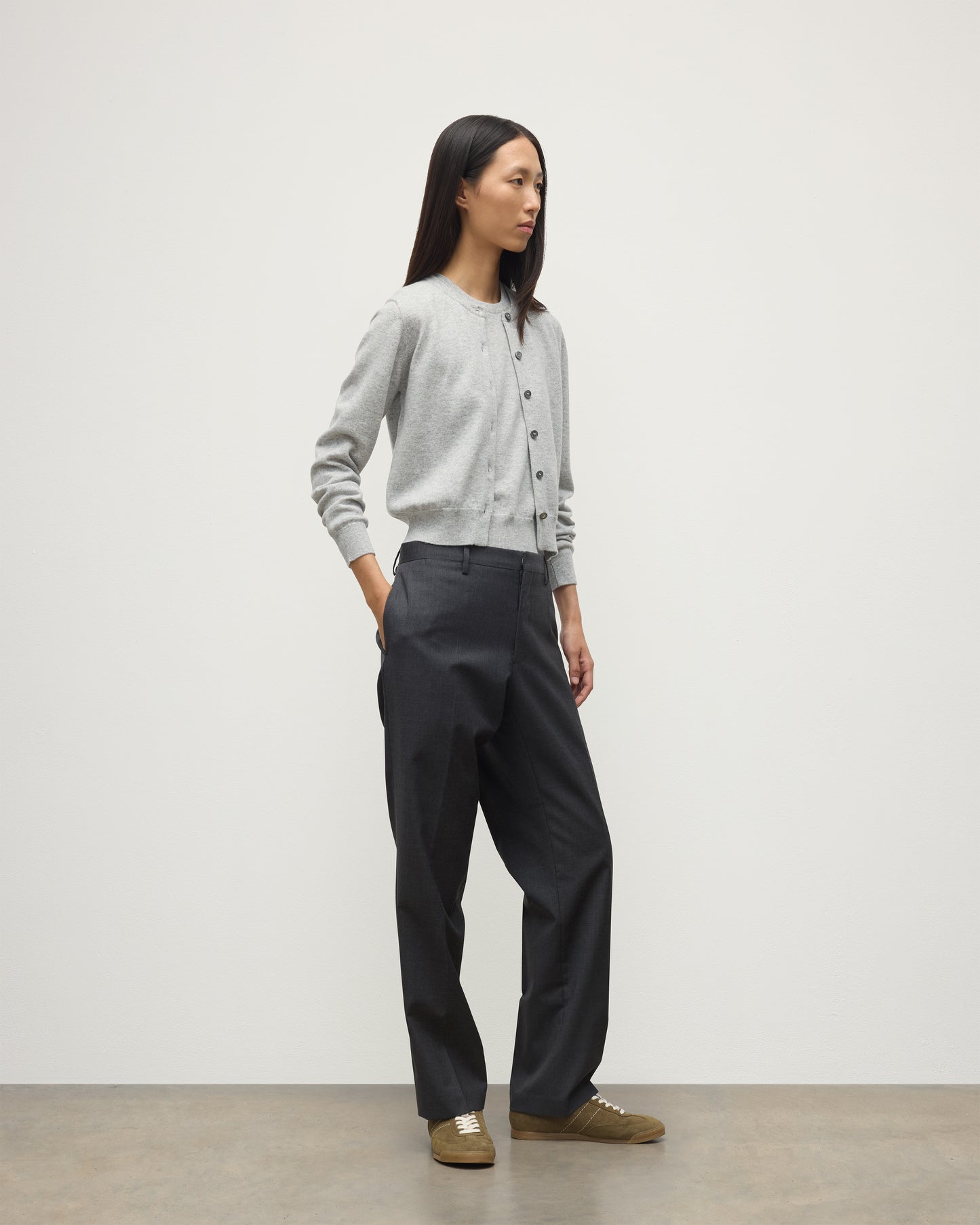 MODEL WEARS JOHNSTONS OF ELGIN WOMENS IRIS CLASSIC CREW CARDIGAN GREY WITH GREY TROUSERS AND TRAINERS  100% CASHMERE KAP05704HA0399