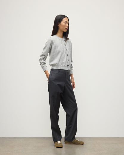 MODEL WEARS JOHNSTONS OF ELGIN WOMENS IRIS CLASSIC CREW CARDIGAN GREY WITH GREY TROUSERS AND TRAINERS  100% CASHMERE KAP05704HA0399